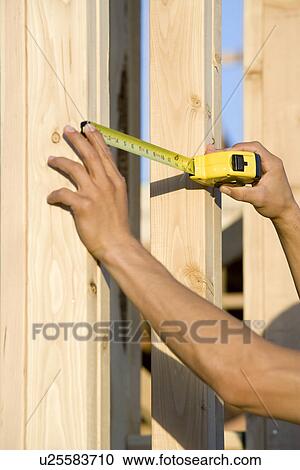 Measuring wooden elements of house construction View Large Photo Image Stock Image - Measuring wooden elements of house construction. Fotosearch