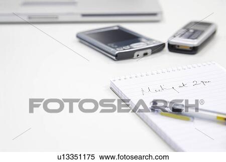 Meeting Note by personal data assistant laptop and cell phone, close up View Large Photo Image Stock Photography - Meeting Note by personal data assistant laptop and cell phone, close up. Fotosearch