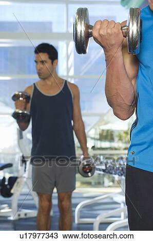 Stock Image - Men Weightlifting With Dumbbells. Fotosearch