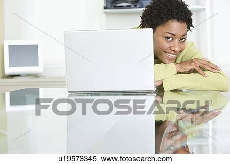 Stock Photography - Mid-adult business woman looking at camera. Fotosearch