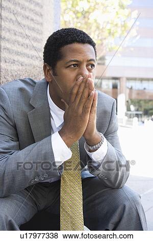 Mid-adult businessman outdoors, thinking View Large Photo Image Stock Photo - Mid-adult businessman outdoors, thinking. Fotosearch
