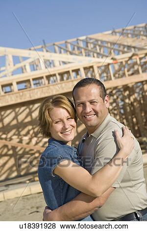 Mid-adult couple at construction site, portrait View Large Photo Image Stock Photo - Mid-adult couple at construction site, portrait. Fotosearch