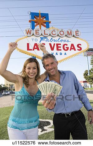 Mid-adult couple in front of Welcome to Las Vegas sign, portrait View Large Photo Image Stock Photograph - Mid-adult couple in front of Welcome to Las Vegas sign, portrait. Fotosearch