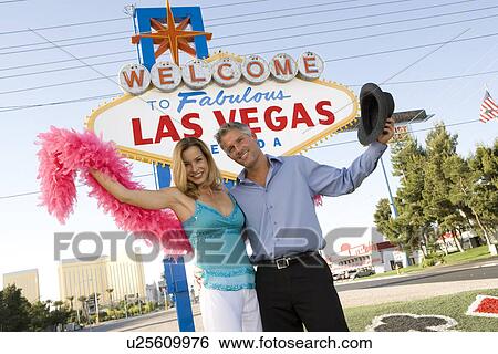 Mid-adult couple in front of Welcome to Las Vegas sign, portrait View Large Photo Image Stock Photograph - Mid-adult couple in front of Welcome to Las Vegas sign, portrait. Fotosearch
