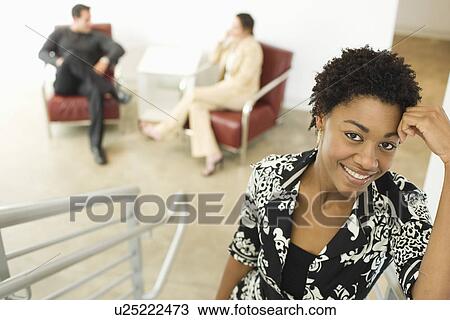 Mid-adult female office worker looking at camera View Large Photo Image Stock Image - Mid-adult female office worker looking at camera. Fotosearch