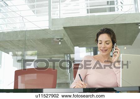 Mid-adult office worker in office View Large Photo Image Stock Image - Mid-adult office worker in office. Fotosearch