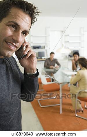 Stock Photo - Mid-adult office worker on the phone. Fotosearch
