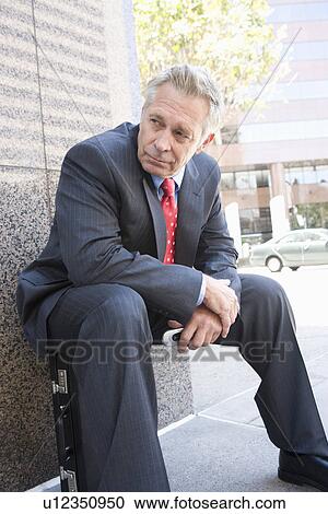 Middle-aged businessman relaxing outdoors View Large Photo Image Stock Image - Middle-aged businessman relaxing outdoors. Fotosearch