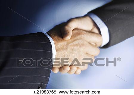 Middle-aged businessmen shaking hands, close-up, digitally enhanced View Large Photo Image Stock Photography - Middle-aged businessmen shaking hands, close-up, digitally enhanced. Fotosearch
