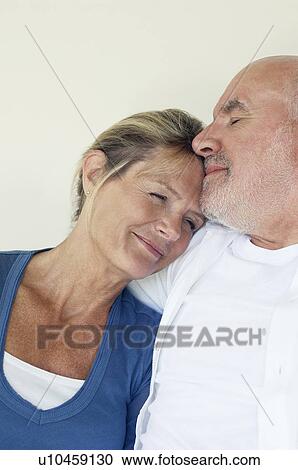 Stock Image - Middle Aged Couple embracing, head and shoulders. Fotosearch