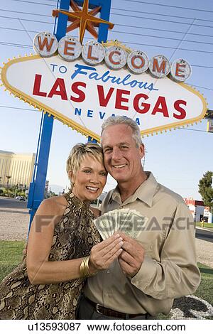 Middle-aged couple in front of Welcome to Las Vegas sign, portrait View Large Photo Image Stock Photo - Middle-aged couple in front of Welcome to Las Vegas sign, portrait. Fotosearch