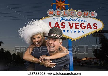 Middle-aged couple in front of Welcome to Las Vegas sign, portrait View Large Photo Image Stock Photo - Middle-aged couple in front of Welcome to Las Vegas sign, portrait. Fotosearch