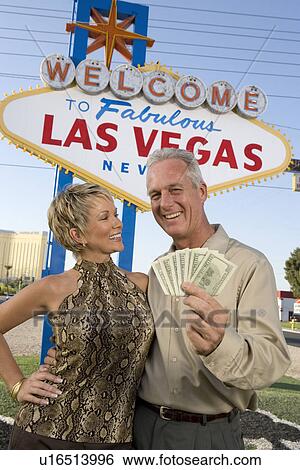 Middle-aged couple in front of Welcome to Las Vegas sign, portrait View Large Photo Image Stock Photograph - Middle-aged couple in front of Welcome to Las Vegas sign, portrait. Fotosearch