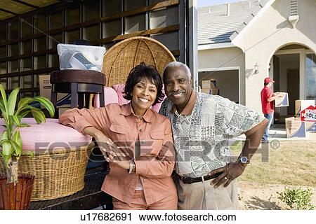 Middle-aged couple standing at back of removal van in front of house, portrait View Large Photo Image Stock Image - Middle-aged couple standing at back of removal van in front of house, portrait. Fotosearch