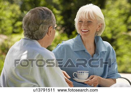 Middle-aged Couple Talking on sofa in back yard, head and shoulders View Large Photo Image Stock Image - Middle-aged Couple Talking on sofa in back yard, head and shoulders. Fotosearch
