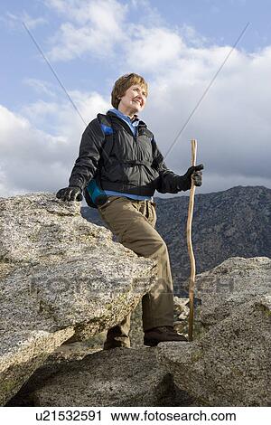 Middle-aged woman standing on rock View Large Photo Image Stock Image - Middle-aged woman standing on rock. Fotosearch