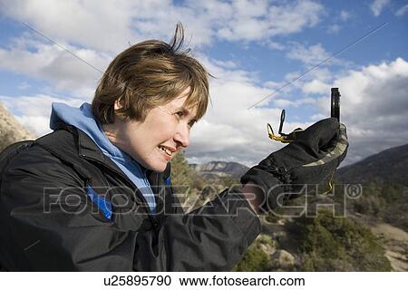 Middle-aged woman using compass View Large Photo Image Stock Image - Middle-aged woman using compass. Fotosearch