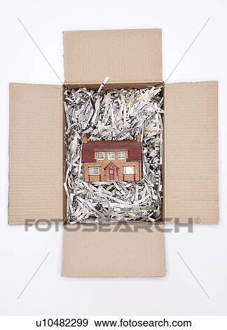 Model house in packing carton with shredded paper, view from above View Large Photo Image Stock Photo - Model house in packing carton with shredded paper, view from above. Fotosearch