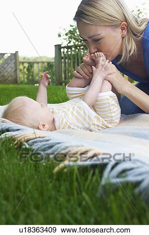 Mother and baby lying on lawn in garden View Large Photo Image Stock Photo - Mother and baby lying on lawn in garden. Fotosearch
