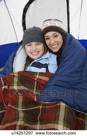 Mother and daughter embracing in tent, portrait View Large Photo Image Stock Photo - Mother and daughter embracing in tent, portrait. Fotosearch