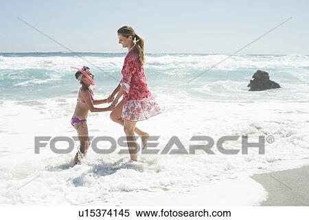 Mother and Daughter Paddling on Beach View Large Photo Image Stock Photography - Mother and Daughter Paddling on Beach. Fotosearch