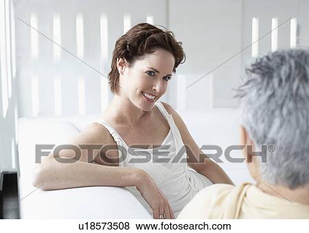 Mother and daughter talking on sofa View Large Photo Image Stock Photo - Mother and daughter talking on sofa. Fotosearch