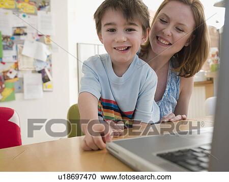 Mother and Son at Table With Laptop View Large Photo Image Stock Image - Mother and Son at Table With Laptop. Fotosearch