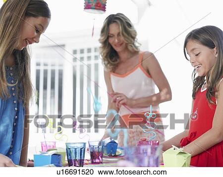 Mother and two daughters (7-9) (10-12) preparing birthday party View Large Photo Image Stock Image - Mother and two daughters (7-9) (10-12) preparing birthday party. Fotosearch