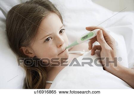 Mother checking temperature of daughter in bed, close up of daughter View Large Photo Image Stock Photography - Mother checking temperature of daughter in bed, close up of daughter. Fotosearch