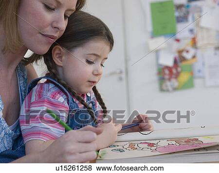 Stock Photo - Mother Coloring With Daughter. Fotosearch