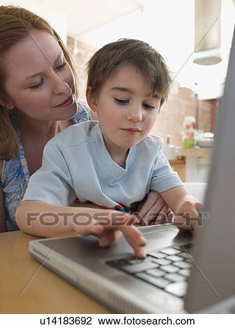 Mother Helping Son Use Laptop View Large Photo Image Stock Image - Mother Helping Son Use Laptop. Fotosearch