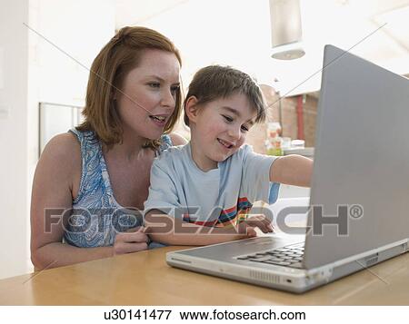 Mother Helping Son Use Laptop View Large Photo Image Stock Photo - Mother Helping Son Use Laptop. Fotosearch