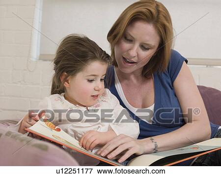 Stock Photo - Mother Reading to Daughter. Fotosearch