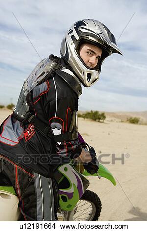 Motocross Racer on bike in desert, (portrait) View Large Photo Image Picture - Motocross Racer on bike in desert, (portrait). Fotosearch