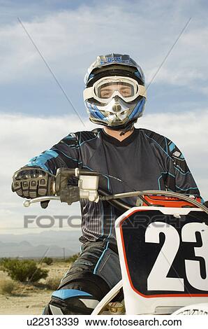 Motocross racer on bike in desert, (portrait) View Large Photo Image Stock Photo - Motocross racer on bike in desert, (portrait). Fotosearch