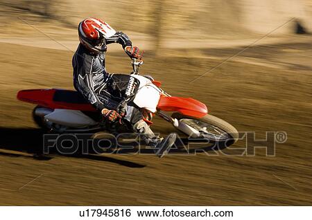 Motocross racer on dirt track View Large Photo Image Stock Photograph - Motocross racer on dirt track. Fotosearch