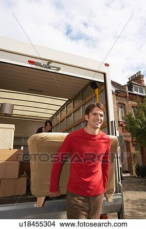 Picture - Moving Couple Carrying Sofa. Fotosearch