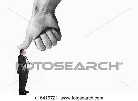 Stock Image - Office worker being bushed by large thumb. Fotosearch