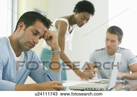 Stock Image - Office workers working on project. Fotosearch