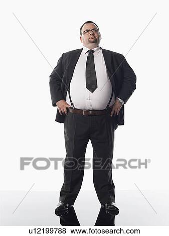 Overweight businessman standing with hands on hips View Large Photo Image Stock Photo - Overweight businessman standing with hands on hips. Fotosearch