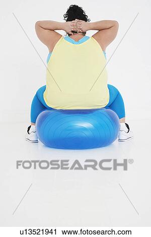 Overweight woman Exercising on exercise Ball, back view View Large Photo Image Stock Image - Overweight woman Exercising on exercise Ball, back view. Fotosearch