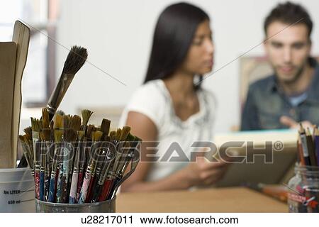 Stock Image - Paint Brushes on Artist's Work Table. Fotosearch