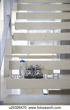 Pair of athletic shoes and water bottle on stairs View Large Photo Image Stock Image - Pair of athletic shoes and water bottle on stairs. Fotosearch