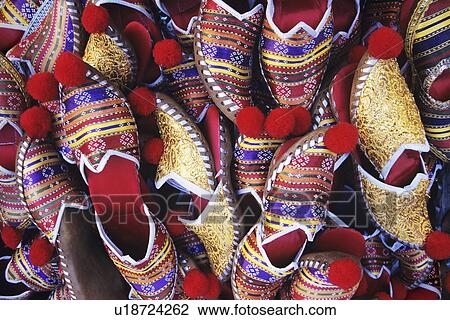Stock Image - Pairs of Babouches stacked together, view from above. Fotosearch