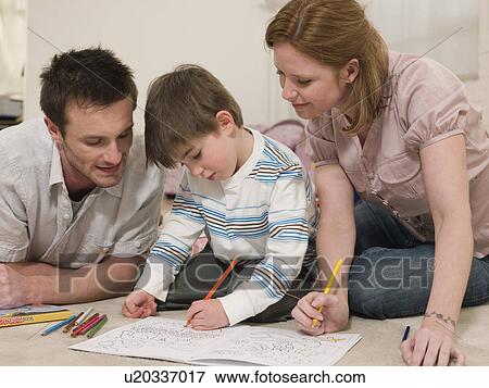 Stock Photo - Parents on Floor Coloring With Son. Fotosearch