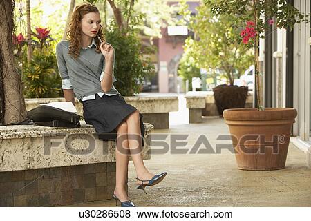Stock Photo - Pensive young woman in street. Fotosearch