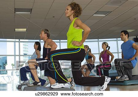 Stock Photo - People Exercising in Step Aerobics Class. Fotosearch