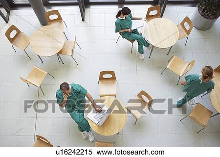 Stock Photography - Physicians During Work Break sitting in cafeteria, view from above. Fotosearch