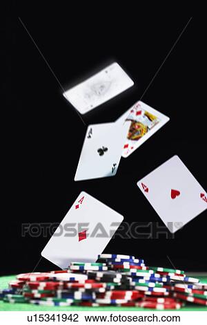Playing cards falling on pile of gambling chips, in studio View Large Photo Image Stock Image - Playing cards falling on pile of gambling chips, in studio. Fotosearch