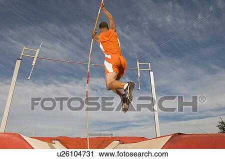 Pole vaulted taking off View Large Photo Image Stock Image - Pole vaulted taking off. Fotosearch